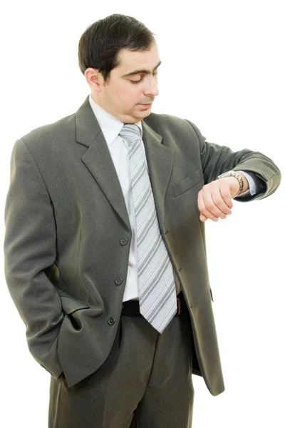 Uomo d'affari che guarda l'orologio su uno sfondo bianco . — Foto Stock