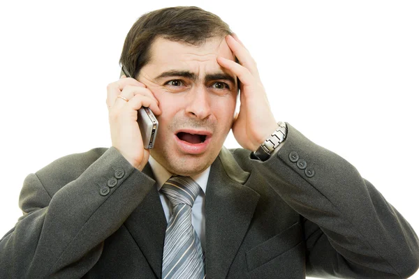 Affärsman i nöd talar via telefon på vit bakgrund — Stockfoto