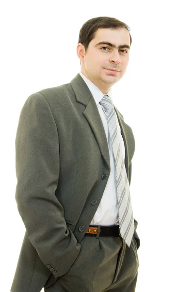 Portret młodego biznesmena stałego z rękami w kieszeni. — Zdjęcie stockowe