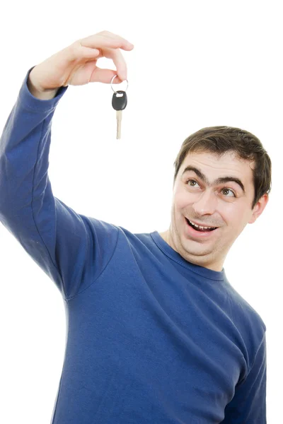 stock image Young man holding keys in his hand, white background