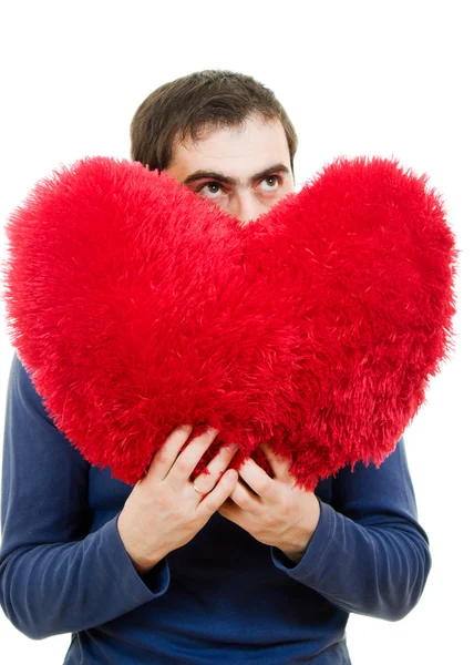 Un hombre sosteniendo un gran corazón rojo sobre un fondo blanco . —  Fotos de Stock