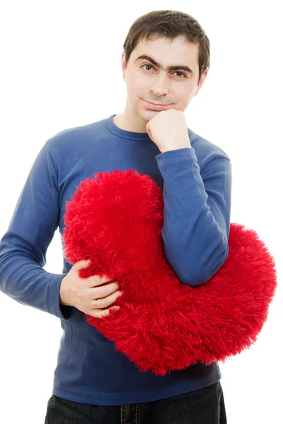 Un hombre sosteniendo un gran corazón rojo sobre un fondo blanco . — Foto de Stock