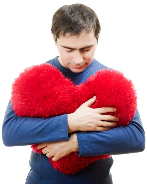 Um homem segurando um grande coração vermelho em um fundo branco . — Fotografia de Stock