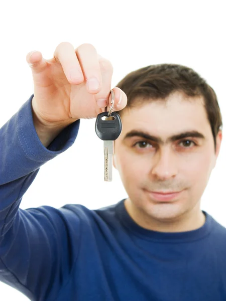 stock image Young man holding keys in his hand, white background