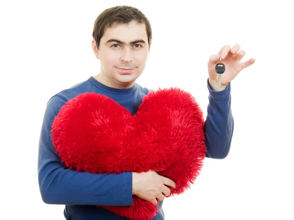 Człowiek posiadający duże czerwone serce i klucz na białym tle. — Zdjęcie stockowe