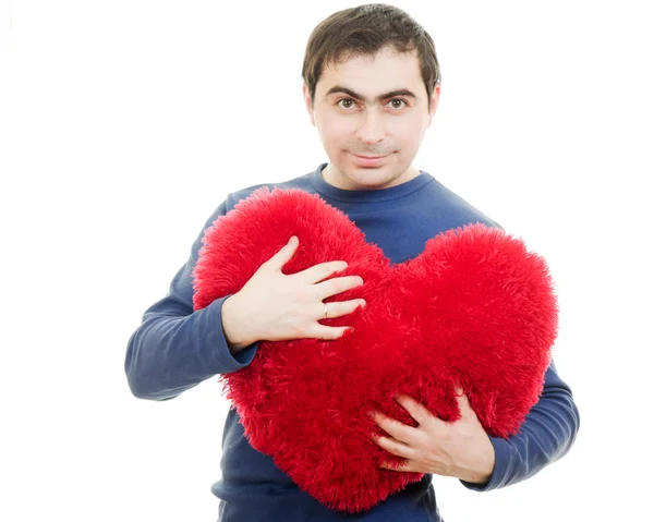 Beyaz bir arka plan üzerinde büyük bir kırmızı kalp tutan bir adam. — Stok fotoğraf