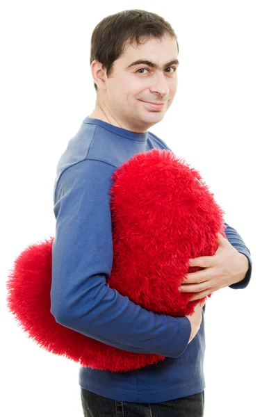 Чоловік тримає велике червоне серце на білому тлі . — стокове фото