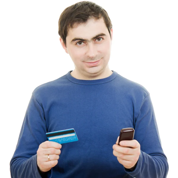 Man met een betaalkaart en mobiele telefoon op een witte achtergrond. — Stockfoto