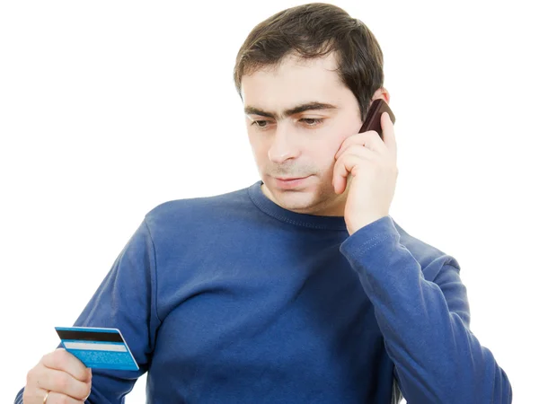 Hombre con tarjeta de débito y teléfono móvil sobre fondo blanco . —  Fotos de Stock