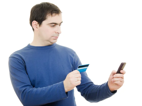 Homem com cartão de débito e telemóvel sobre fundo branco . — Fotografia de Stock