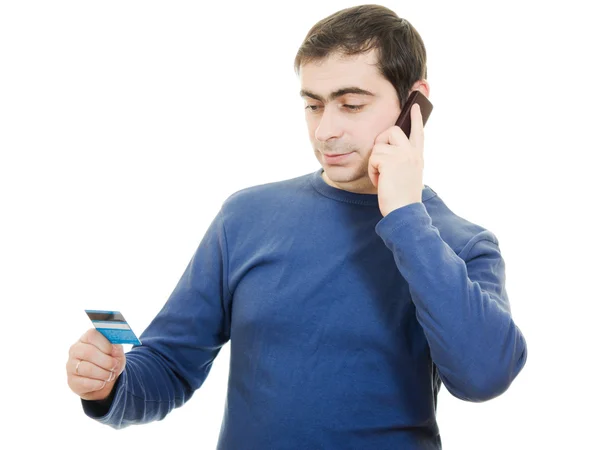 Άνθρωπος με μια χρεωστική κάρτα και το κινητό τηλέφωνο σε λευκό φόντο. — Φωτογραφία Αρχείου