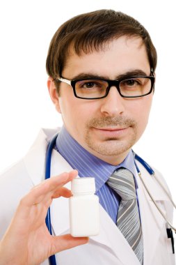 The doctor man holding a container of vitamins on a white background. clipart