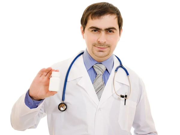 stock image The doctor man holding a container of vitamins on a white background.