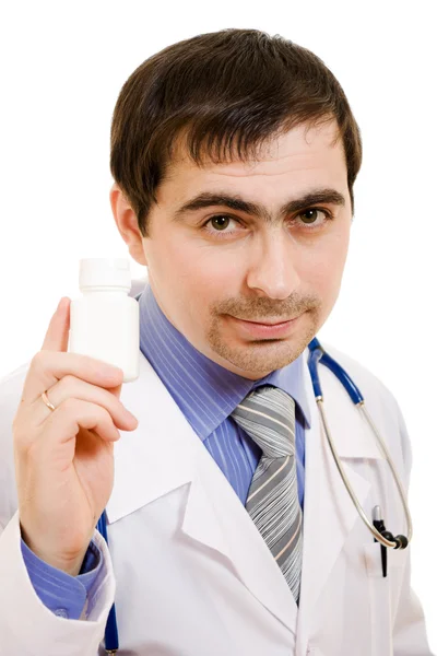 De arts man houden van een container van vitaminen op een witte achtergrond. — Stockfoto