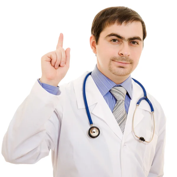 Médico masculino aponta o dedo para cima em um fundo branco . — Fotografia de Stock