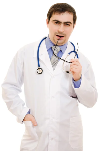 A doctor with a stethoscope and glasses thinking on a white background Royalty Free Stock Images