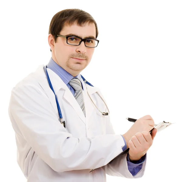 Мужчина врач пишет на таблице документов на белом фоне . Лицензионные Стоковые Изображения