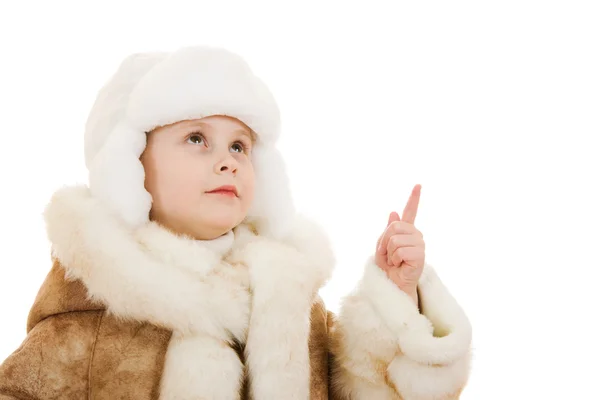 Girl in a sheepskin coat and hat looking up on white background. — Stock Photo, Image