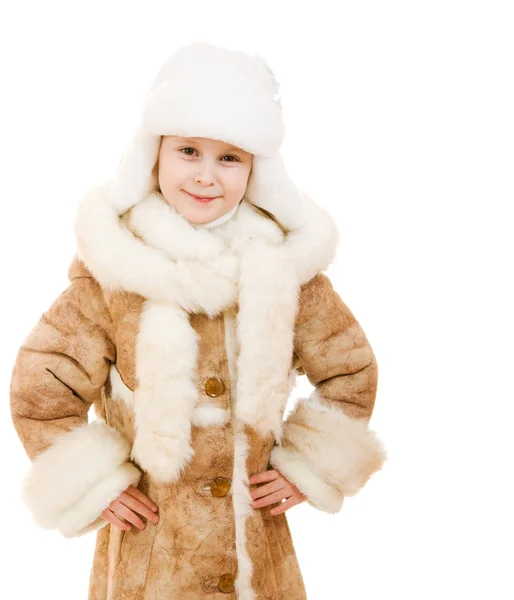 Uma menina de casaco de pele e chapéu sorrindo no fundo branco . — Fotografia de Stock