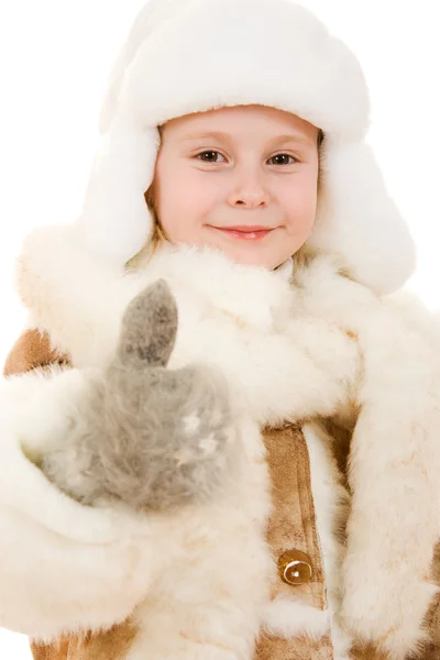 Girl in a gesture of warm clothing shows okay on a white background. — Stock Photo, Image