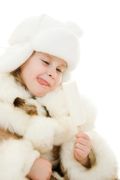 The girl in warm clothes eating ice cream on white background. — Stock Photo, Image