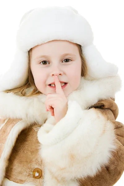 The girl in warm clothes shows a gesture of silence on white background. — Stock Photo, Image