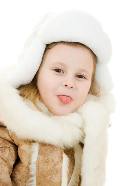 The girl in warm clothes shows tongue on white background. — Stock Photo, Image