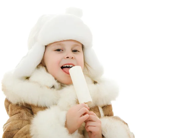 stock image The girl in warm clothes eating ice cream on white background.