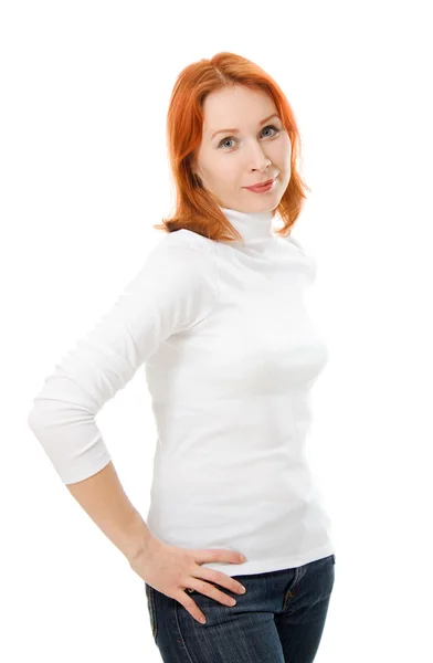 Uma menina bonita com cabelo vermelho com as mãos na cintura em um fundo branco . — Fotografia de Stock