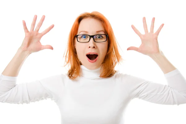 A beautiful girl with red hair wearing glasses was surprised on a white background. — Stock Photo, Image