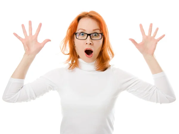 A beautiful girl with red hair wearing glasses was surprised on a white background. — Stock Photo, Image