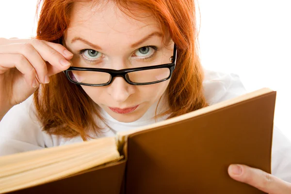 Hermosa chica pelirroja en gafas lee libro . — Foto de Stock