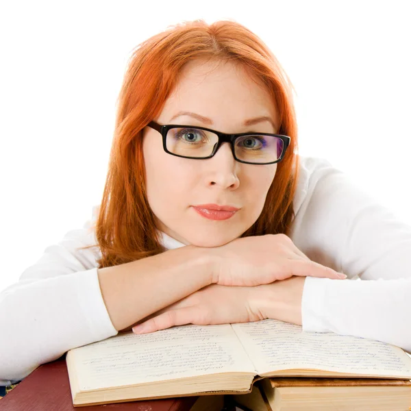 Beautiful red-haired girl in glasses reads book. — Stock Photo, Image