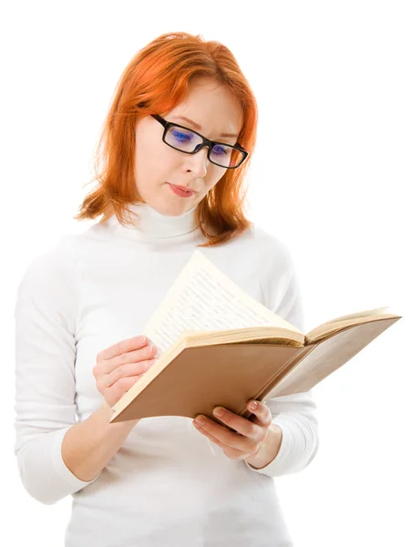 Piękna rudowłosa dziewczyna w okularach czyta książki. — Zdjęcie stockowe