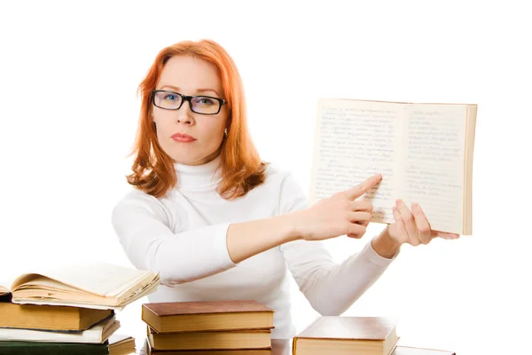 Beautiful red-haired girl in glasses reads book — Stock Photo, Image