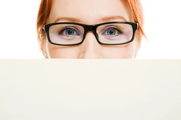 Business woman with glasses hidden behind a white sheet of paper — Stock Photo, Image