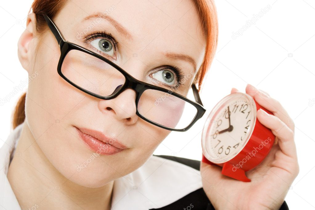 Businesswoman wearing glasses listening clock .