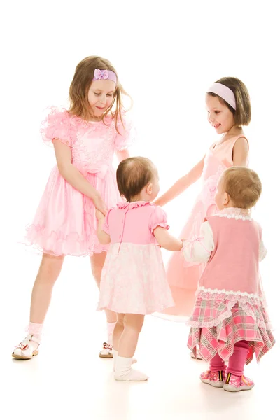 Four friends in a pink dress plays — Stock Photo, Image