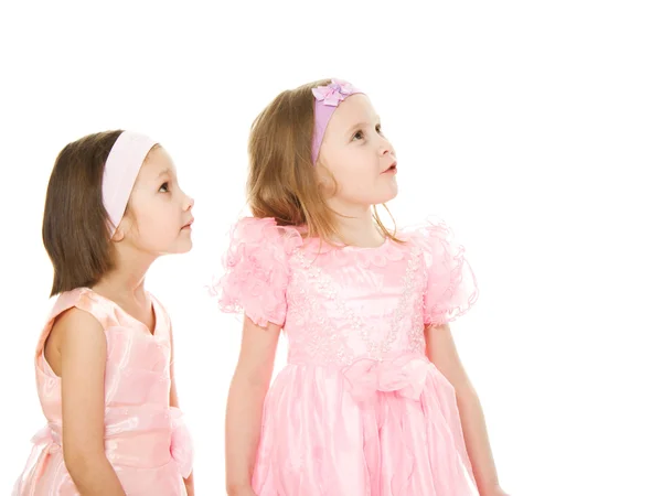 Two friends in a pink dress looking up — Stock Photo, Image