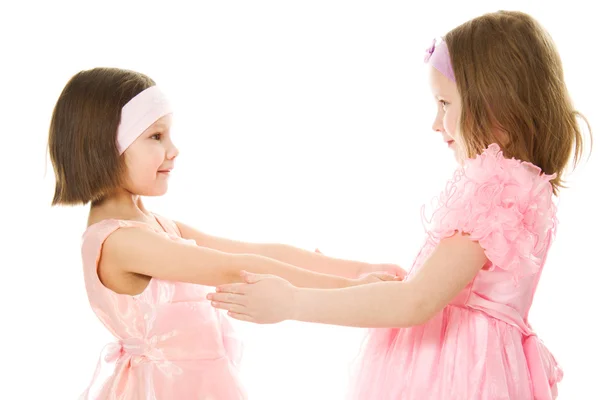Two girlfriends hugging dresses in pink — Stock Photo, Image