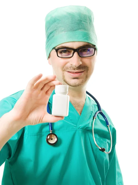 The doctor man holding a container of vitamins on a white background. — Stock Photo, Image