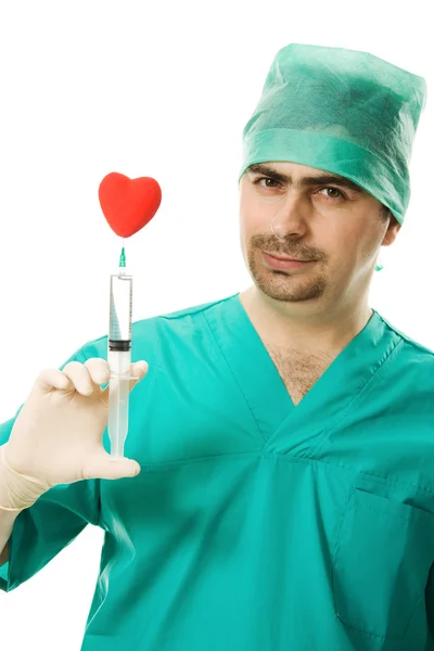 Doctor with a heart and syringe in his hand — Stock Photo, Image