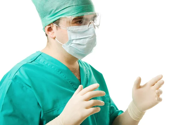 Mannelijke chirurg dragen van handschoenen en een masker op een witte achtergrond. Rechtenvrije Stockfoto's