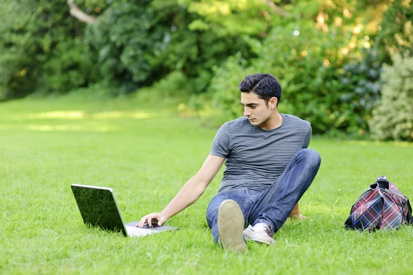 Handsome man sit in the park — Stock Photo, Image