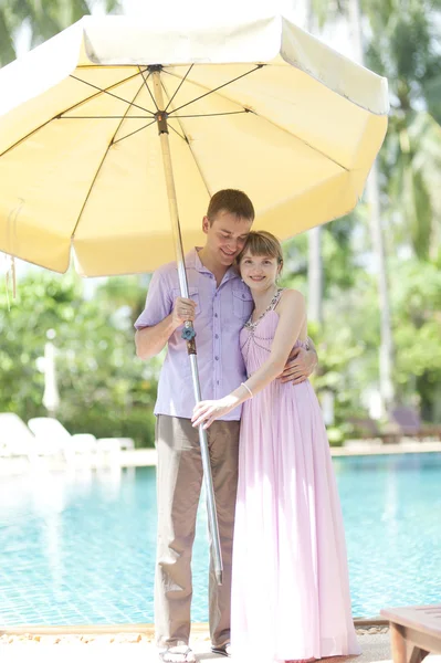 Couple with big sun umbrella — Stock Photo, Image