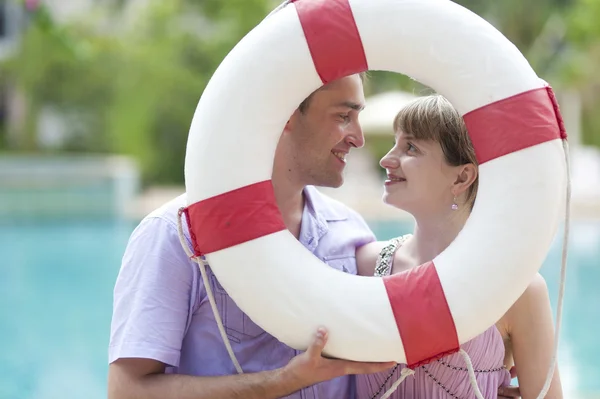Young couple with ring-buoy — Stock Photo, Image