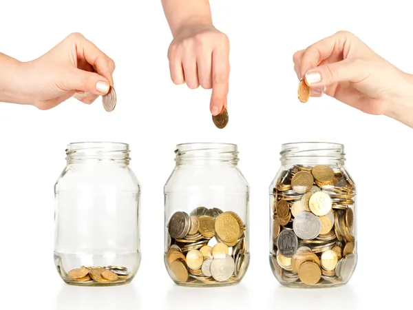 Glass banks for tips with money like diagram and hand — Stock Photo, Image