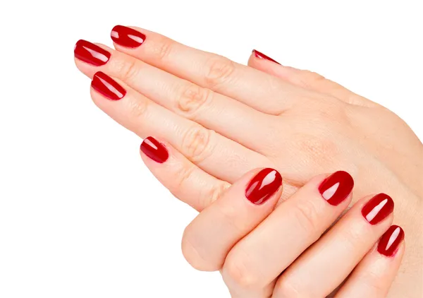 Close up de mãos femininas com manicure vermelho — Fotografia de Stock