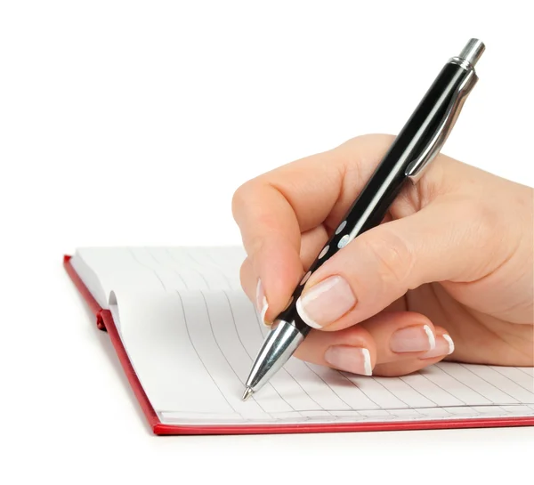 Mano con pluma escribiendo en el cuaderno — Foto de Stock