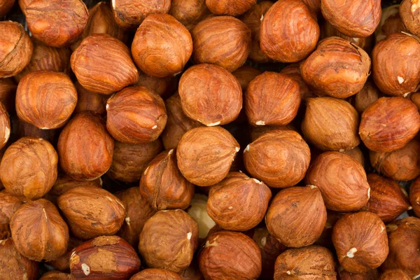 Heap of raw hazelnuts background — Stock Photo, Image